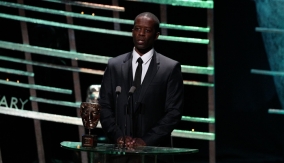 Adrian Lester presents the award