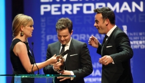 The duo accept the award